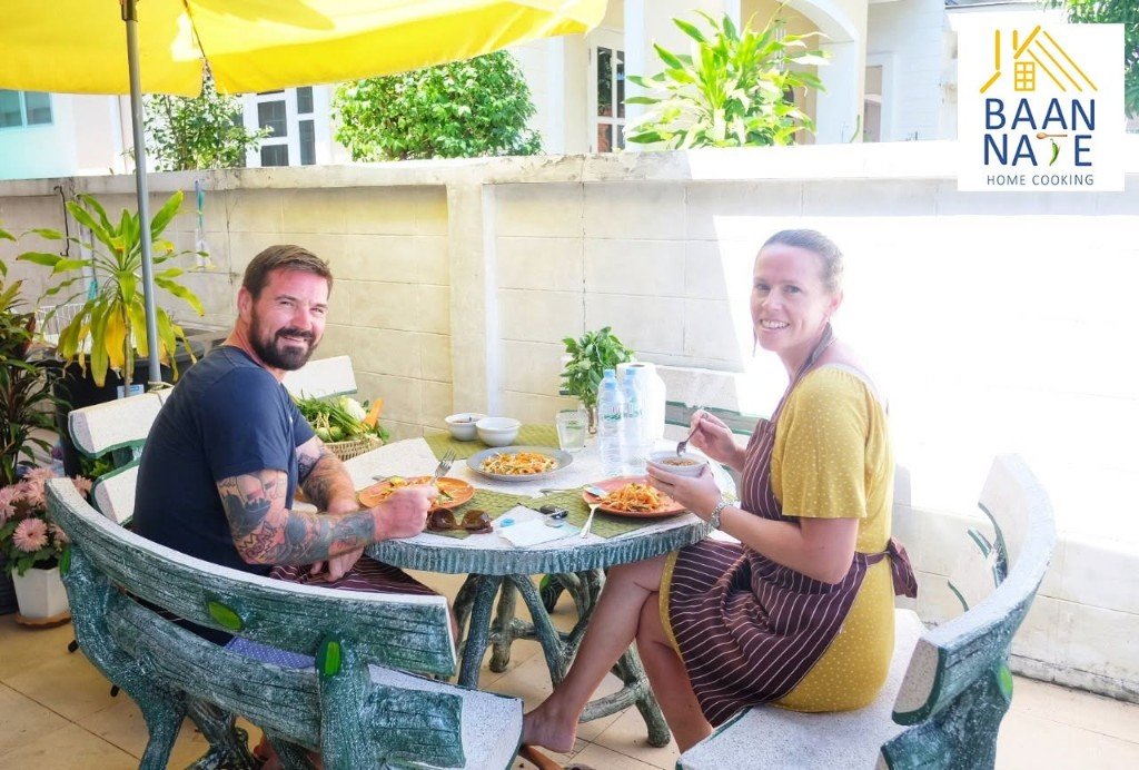 Two guests eating lunch at a table in the garden.