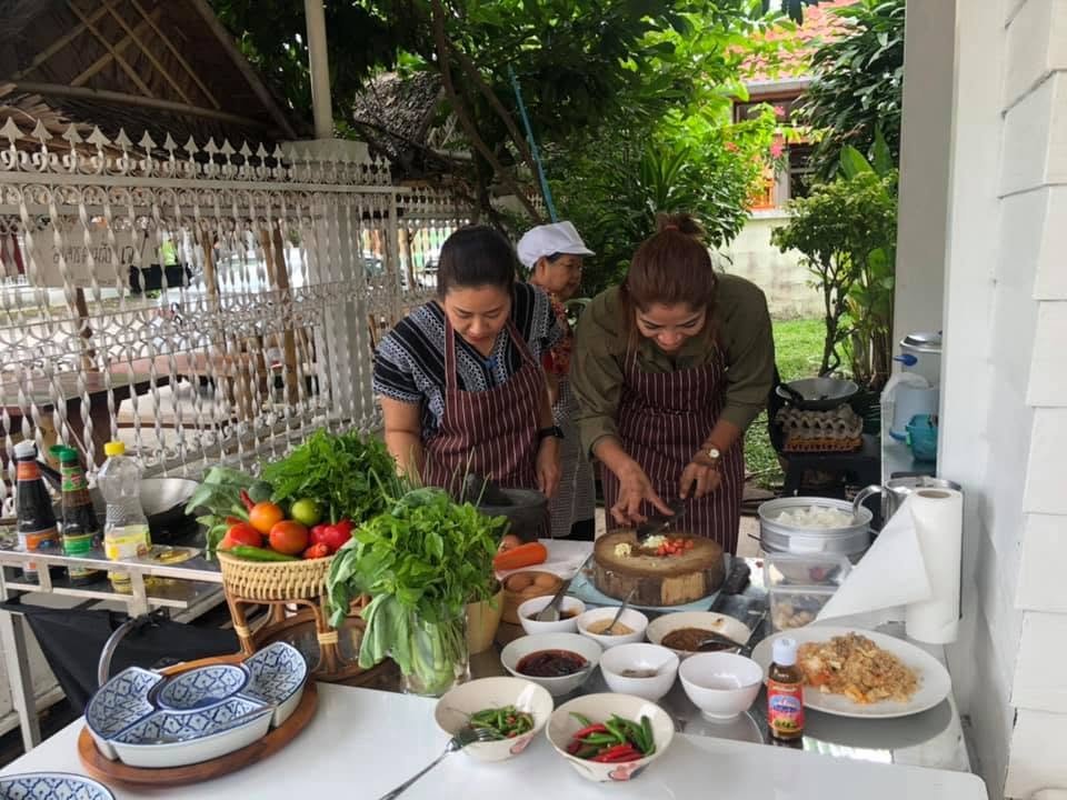 Herbs, vegetables and a chopping block in the garden kitchen.