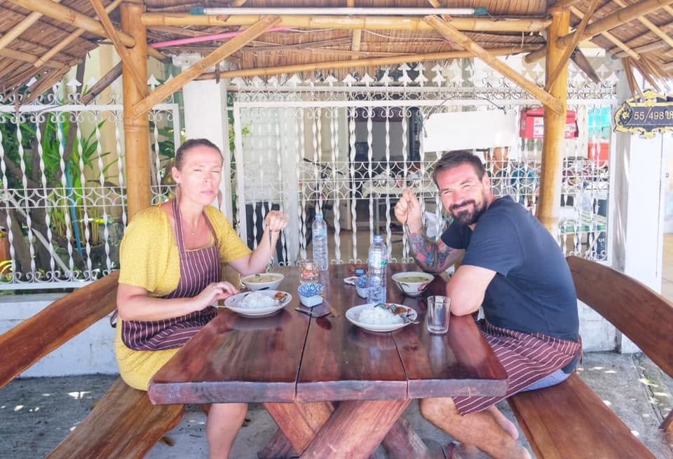Two guests eating lunch under the garden shelter.