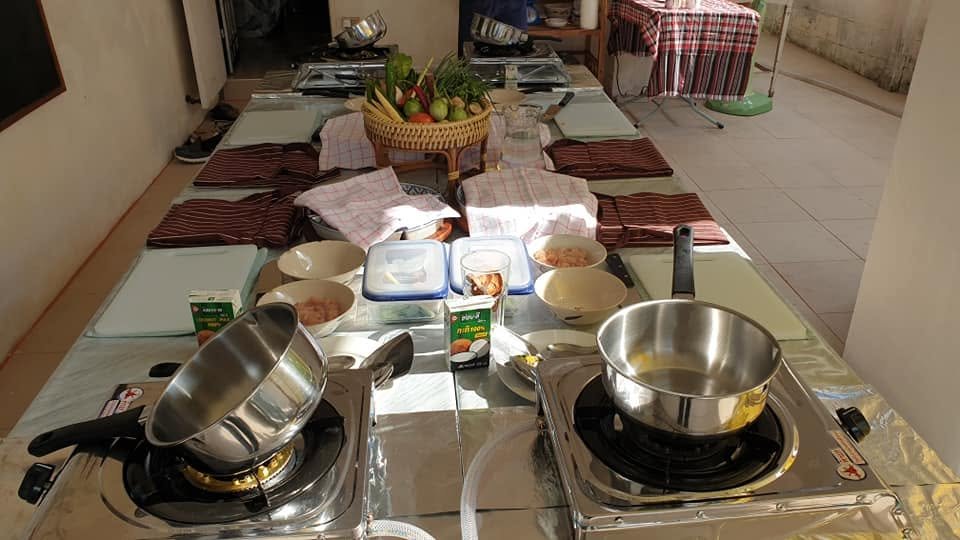 A row of burners and boards set out for a small class.